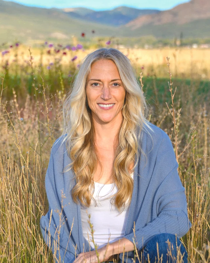 Kellyrose Matthews, seated in a mountain meadow